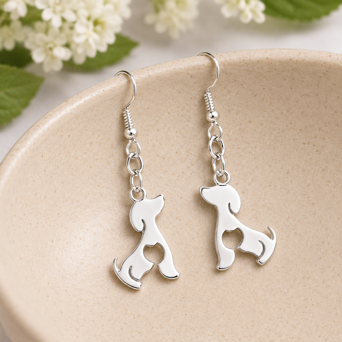 Cat At Heart Dog Earrings - Silver displayed in a lifestyle product photo