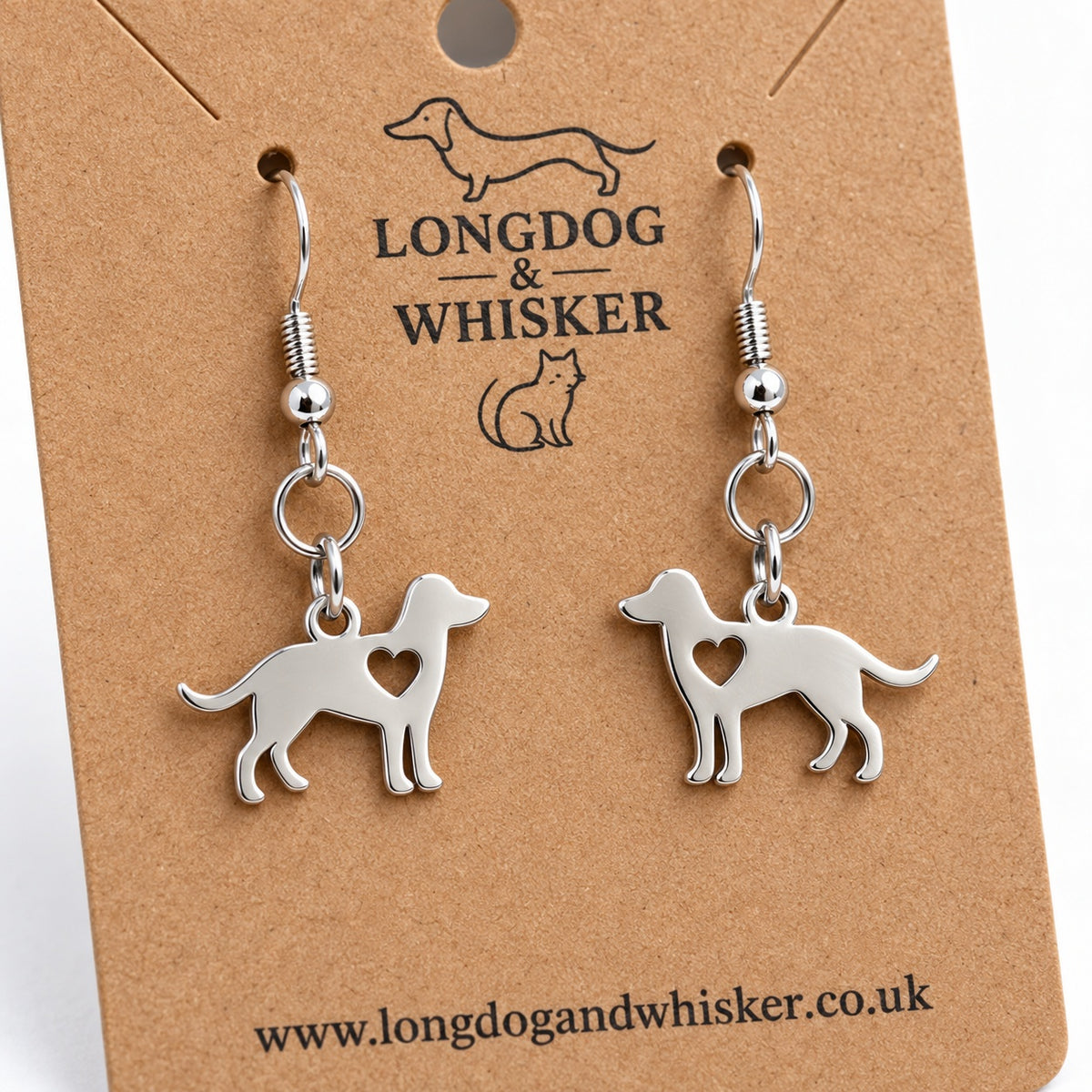 Close-up of the mirrored silver-tone dog charms, heart cut-outs and silver hook fittings