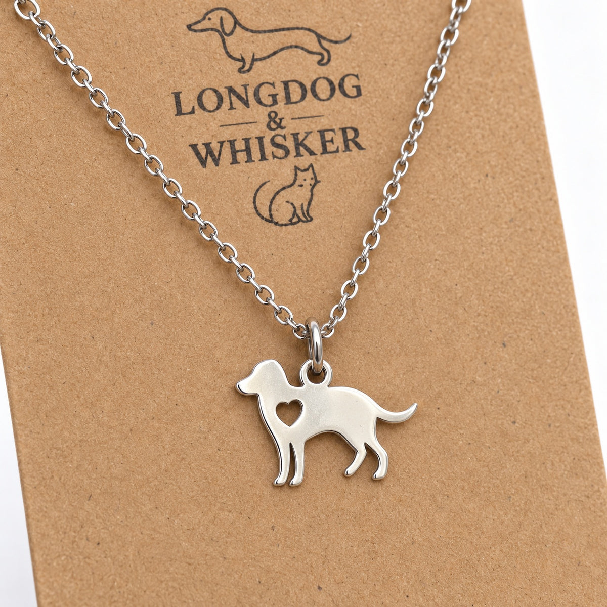 Close-up of the polished silver-tone standing dog pendant and heart-shaped cut-out