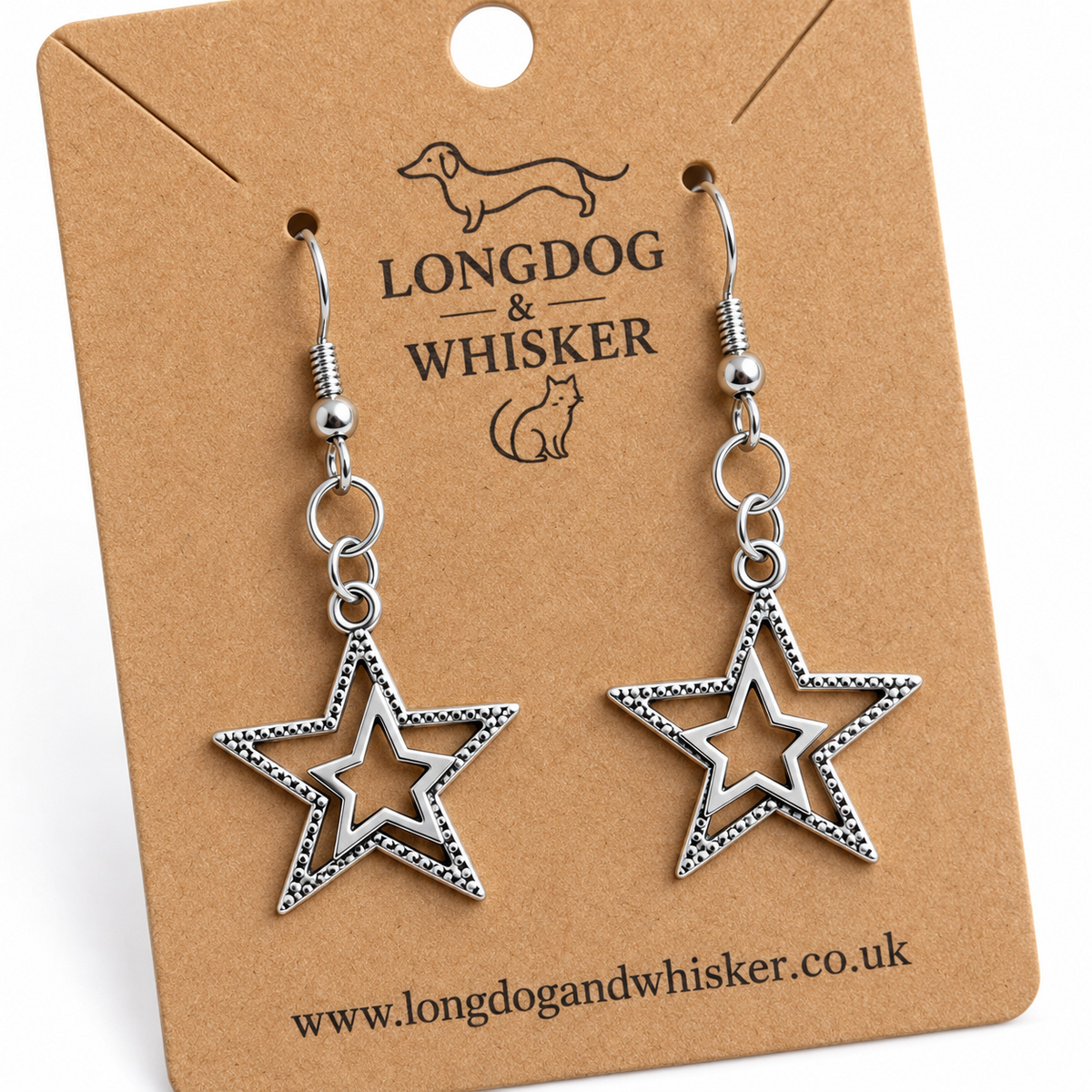 Close-up of silver double star earrings showing textured edges and silver hook fittings.