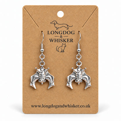 Silver hanging bat drop earrings on Longdog & Whisker kraft card