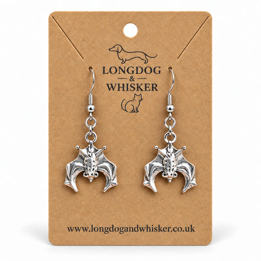 Silver hanging bat drop earrings on Longdog & Whisker kraft card