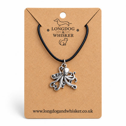 Silver-tone octopus necklace on black cord on a Longdog & Whisker kraft card