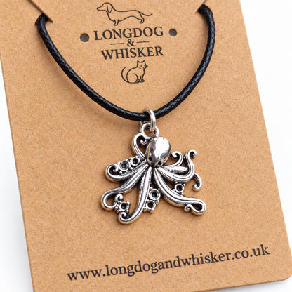 Close-up of the octopus pendant's curled tentacles, sucker detail and black cord connector