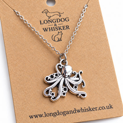 Close-up of the octopus pendant's curled tentacles, sucker detail and silver-tone chain connector