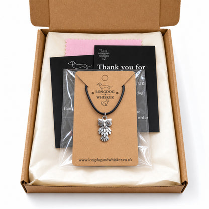 Silver-tone owl black cord necklace in Longdog & Whisker kraft packaging