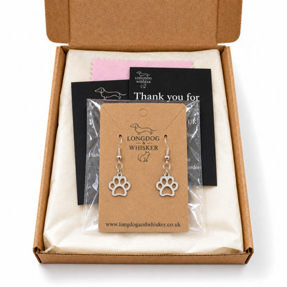 Silver paw print earrings presented in Longdog & Whisker packaging