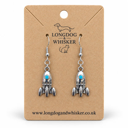 Silver rocket earrings with turquoise portholes on a Longdog & Whisker kraft product card