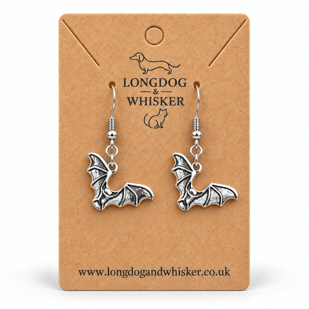 Silver-tone scalloped wing bat drop earrings on a Longdog & Whisker kraft card