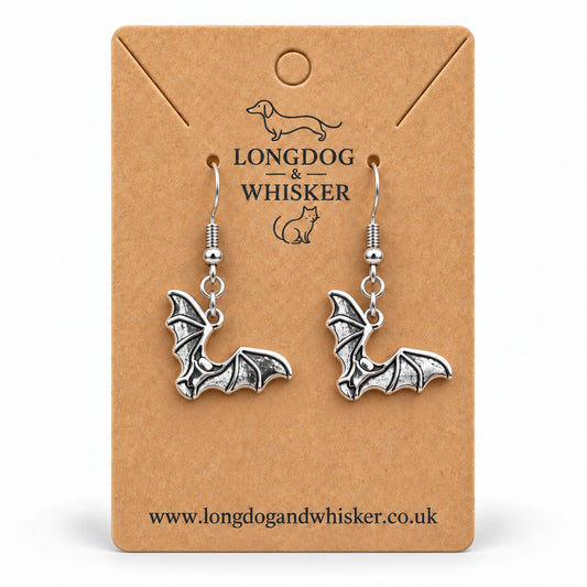 Silver-tone scalloped wing bat drop earrings on a Longdog & Whisker kraft card