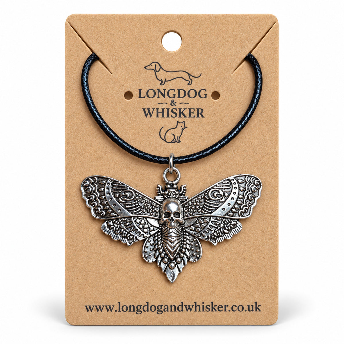 Silver skull moth necklace on black cord, displayed on a Longdog & Whisker kraft card