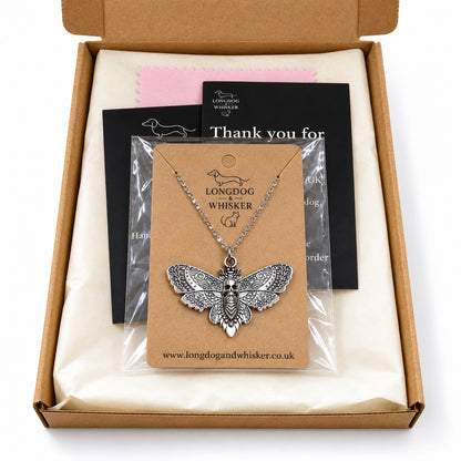Silver skull moth silver-chain necklace in Longdog & Whisker postal packaging