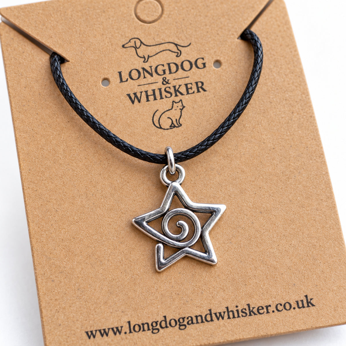 Close-up of the spiral star pendant's open outline, curling centre and black cord connector