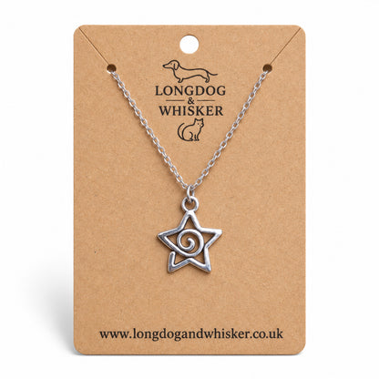 Silver-tone spiral star necklace on a silver-tone chain on a Longdog & Whisker kraft card