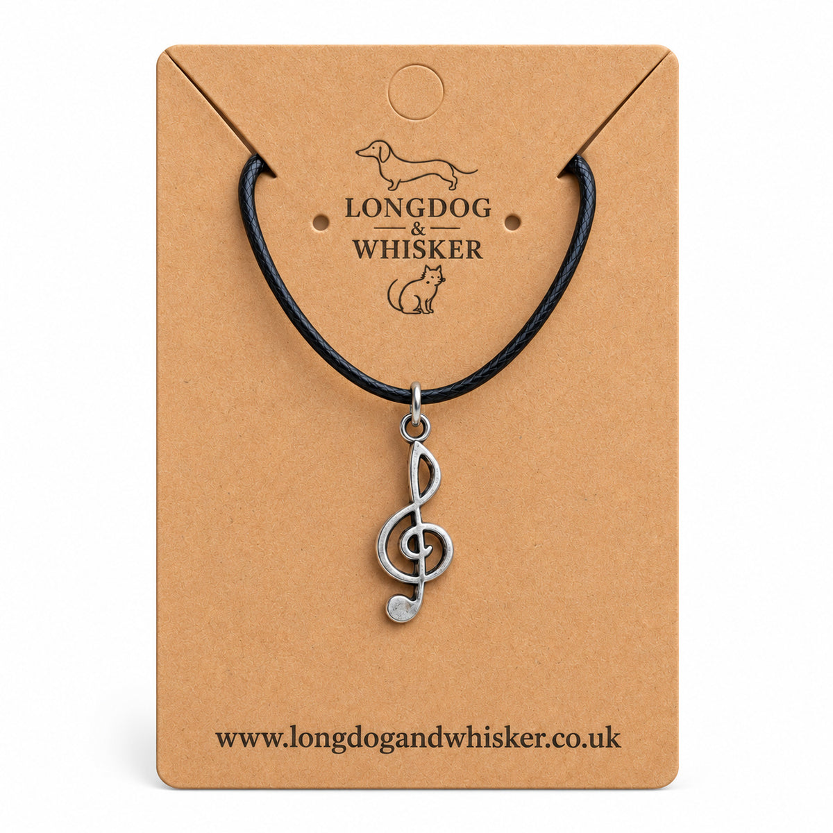 Silver-tone treble clef music note necklace on black cord on its kraft product card