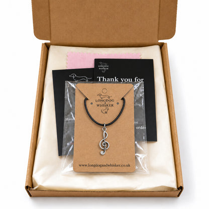 Treble clef black cord necklace in Longdog & Whisker kraft packaging