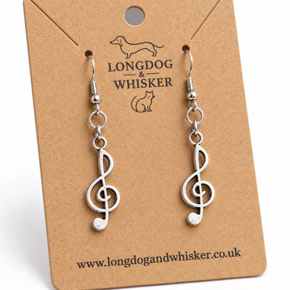 Close-up of the flat treble clef charms and linked earring connectors
