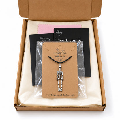Skeleton black-cord necklace in Longdog & Whisker postal packaging