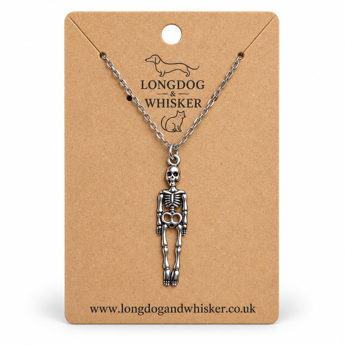 Silver-tone skeleton necklace on a silver chain, displayed on a Longdog & Whisker kraft card