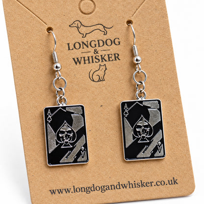 Close-up of the skull and spade details on black playing card earrings
