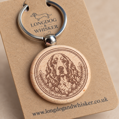 Close-up of Springer Spaniel portrait, leafy border, natural wood edge and silver connector