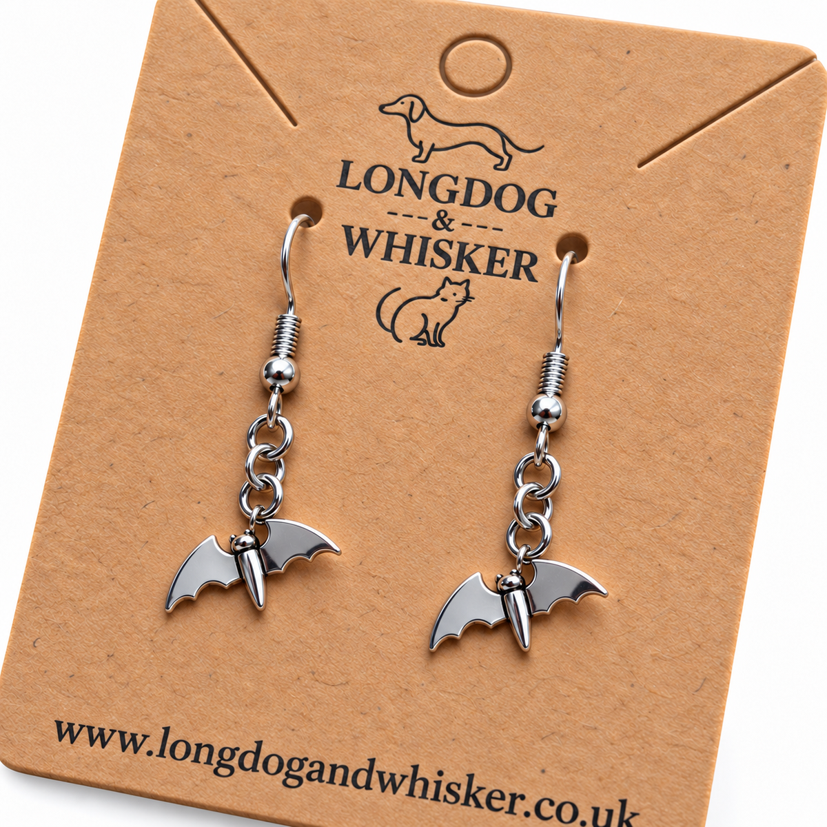 Close detail of smooth stainless steel flying bat earrings
