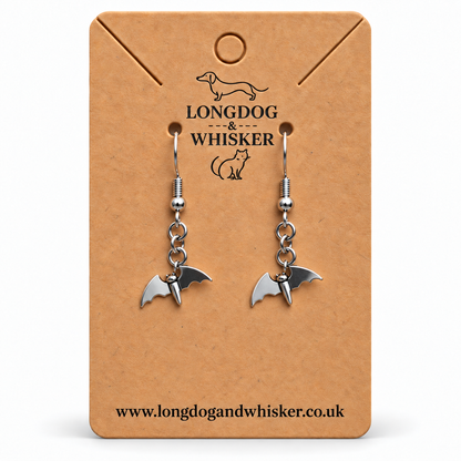 Stainless steel flying bat drop earrings on a Longdog and Whisker card