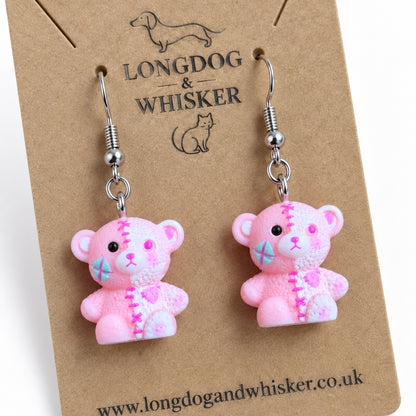 Close detail of Pink Stitched Zombie Bear Earrings and silver-tone hooks