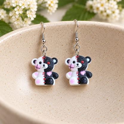 Stitched Zombie Bear Earrings hanging in a ceramic bowl lifestyle scene