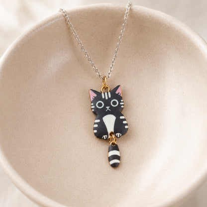 Tick Tock Cat Necklace - Black & White displayed in a lifestyle product photo