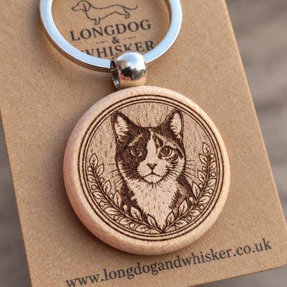 Close-up of the tortoiseshell cat portrait, leafy border, rounded wooden edge and silver-tone connector