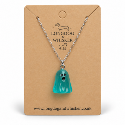 Translucent aqua ghost necklace with silver chain on a Longdog & Whisker kraft display card.