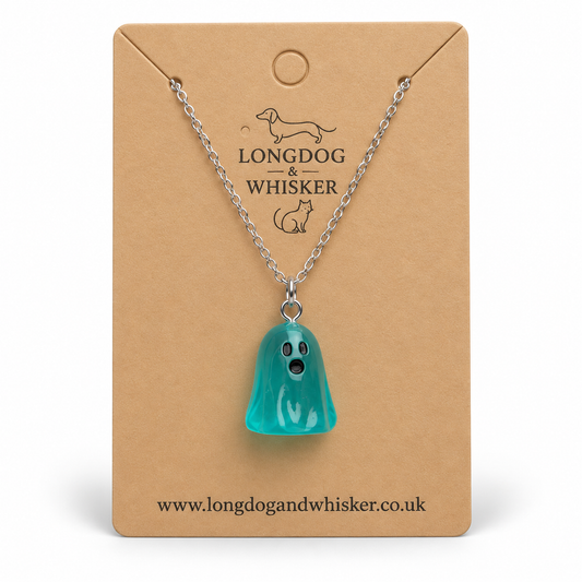 Translucent aqua ghost necklace with silver chain on a Longdog & Whisker kraft display card.