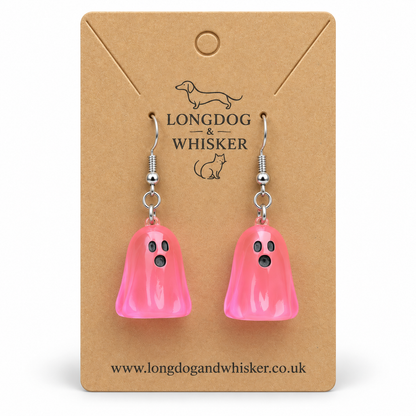 Translucent bright pink ghost earrings on a Longdog & Whisker kraft display card