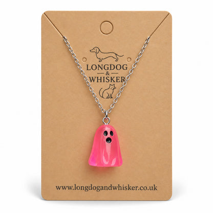 Translucent bright pink ghost necklace with silver chain on a Longdog & Whisker kraft card.