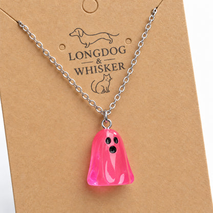 Close-up of the translucent bright pink ghost pendant and silver connecting rings.