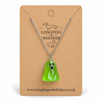 Translucent green ghost necklace with silver chain on a Longdog & Whisker kraft card.