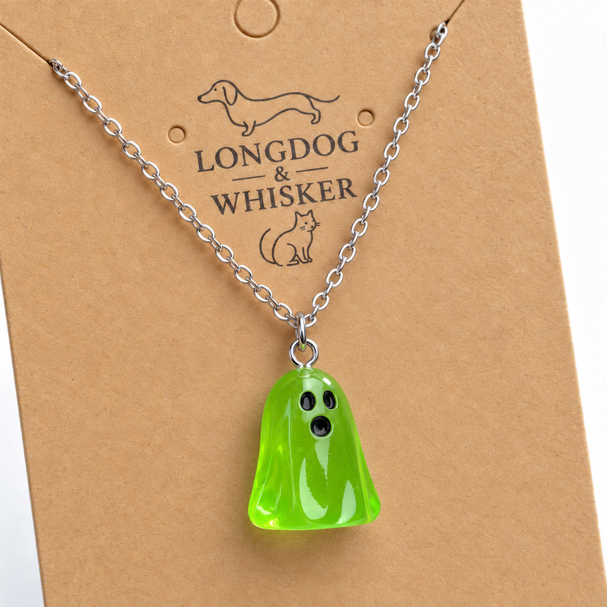 Close-up of the translucent green ghost pendant and silver connecting rings.