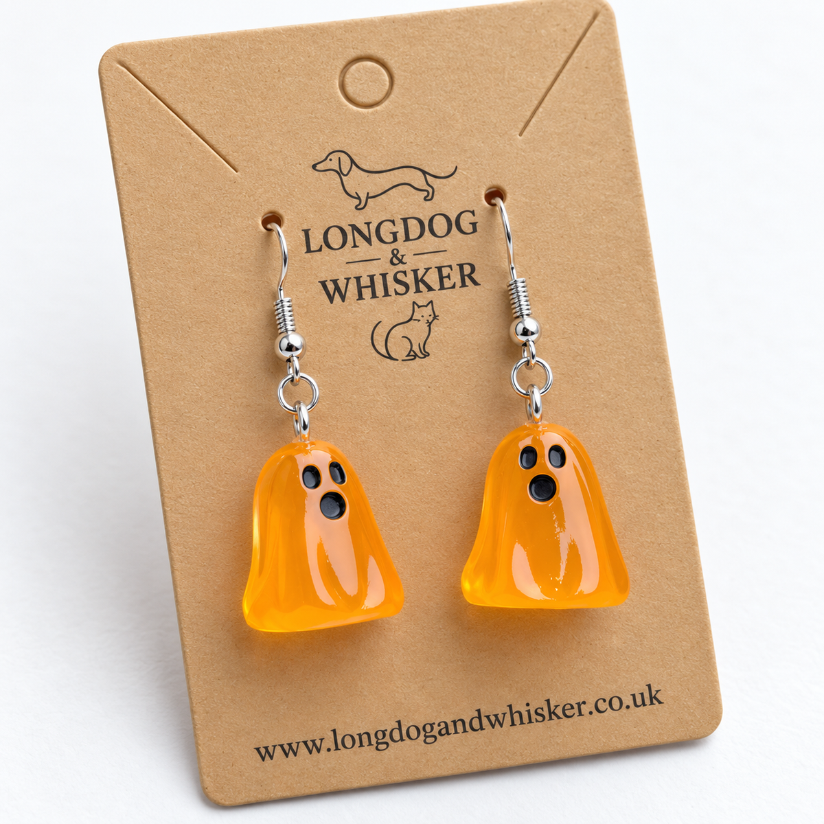 Close-up of translucent orange ghost earrings and silver hooks