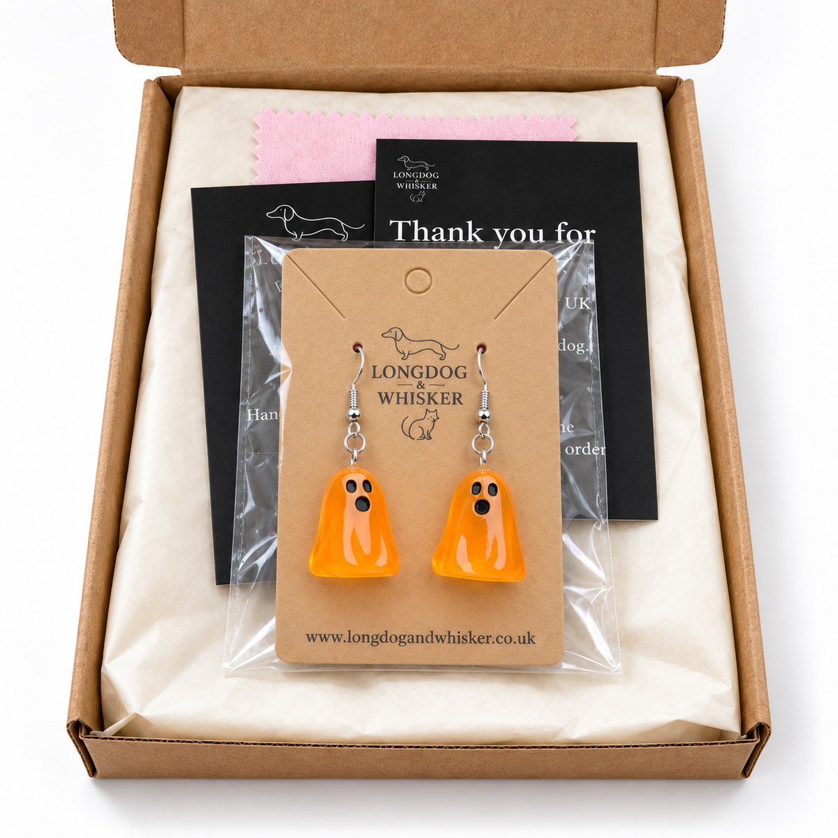Translucent orange ghost earrings in Longdog & Whisker gift packaging