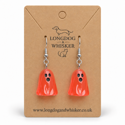 Translucent pale red ghost earrings on a Longdog & Whisker kraft display card