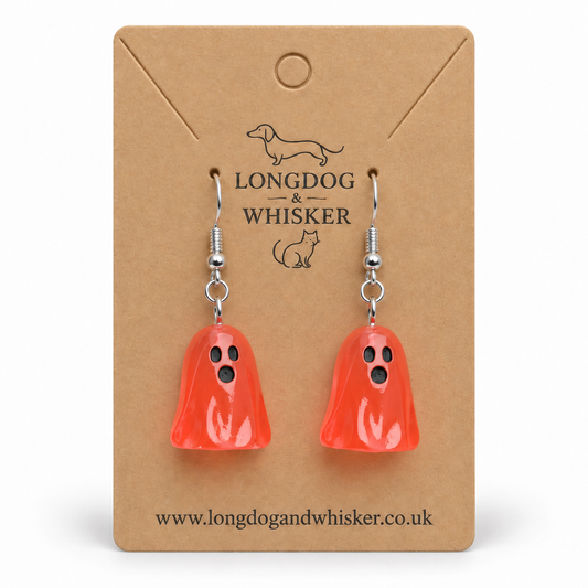 Translucent pale red ghost earrings on a Longdog & Whisker kraft display card
