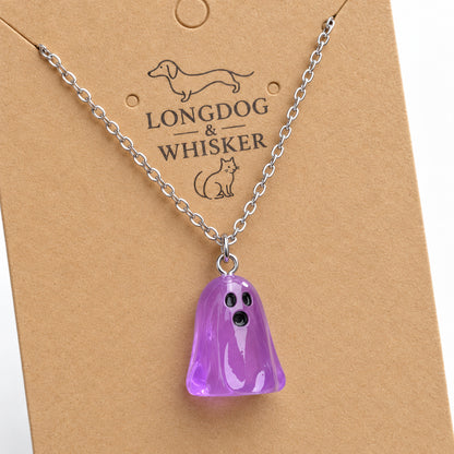 Close-up of the translucent purple ghost pendant and silver connecting rings.