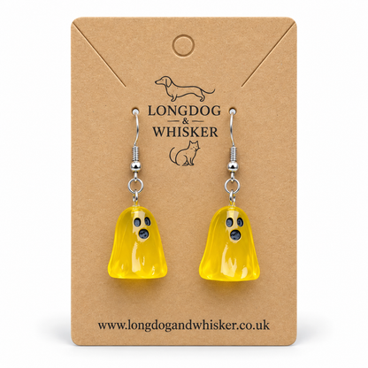 Translucent yellow ghost earrings with silver hooks on a Longdog & Whisker kraft card