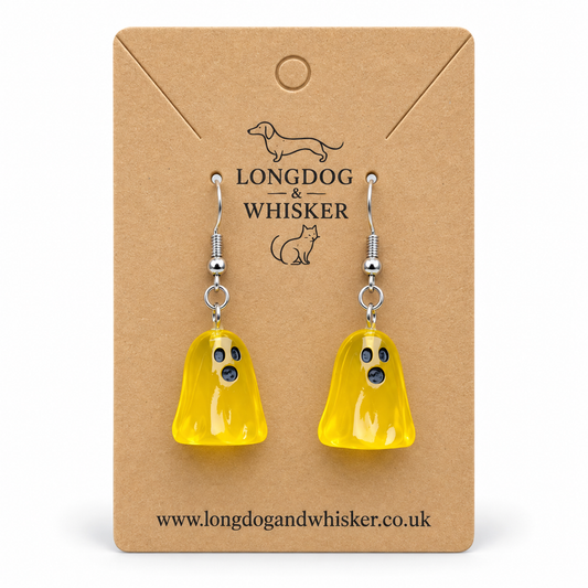 Translucent yellow ghost earrings with silver hooks on a Longdog & Whisker kraft card