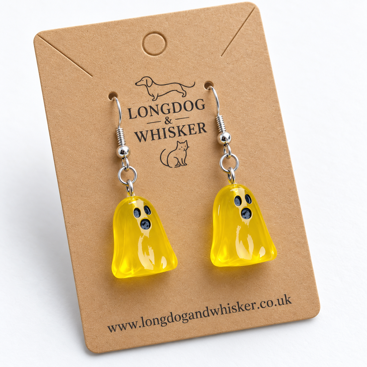 Close-up of translucent yellow ghost earrings and silver hooks