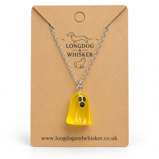 Translucent yellow ghost necklace with silver chain on a Longdog & Whisker kraft card.