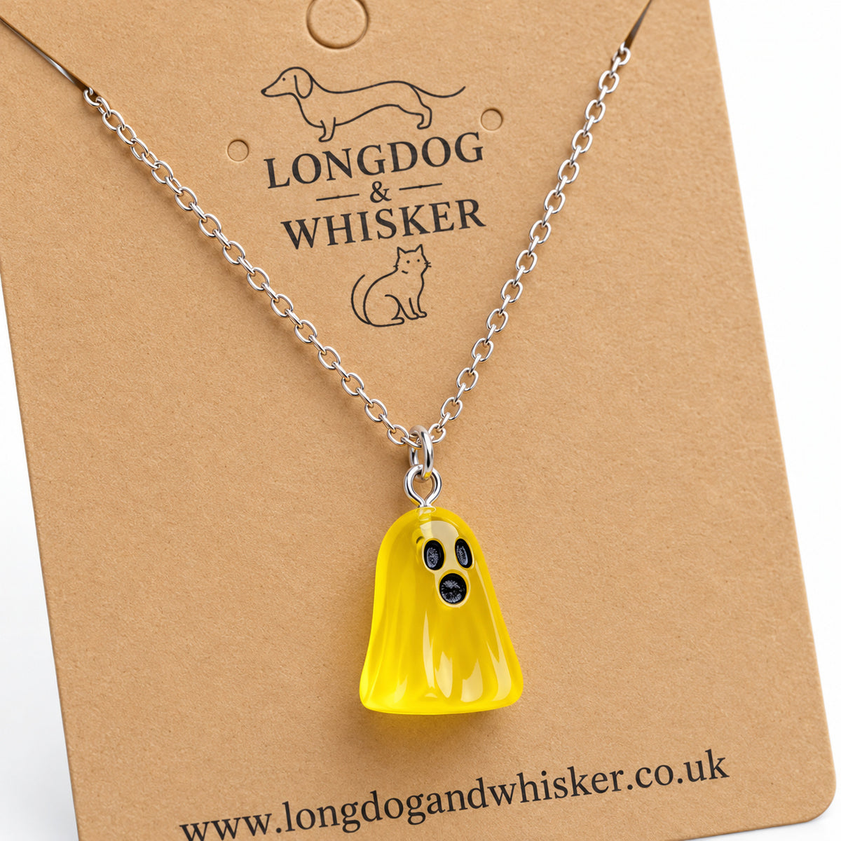 Close-up of the translucent yellow ghost pendant and silver connecting rings.