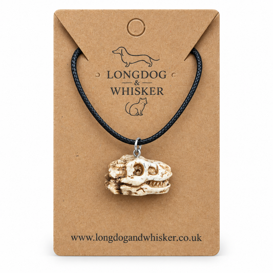 T-Rex dinosaur skull necklace on Longdog & Whisker display card
