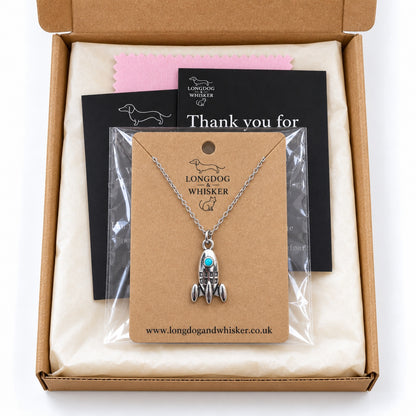 Turquoise porthole rocket necklace on its card in gift-ready Longdog & Whisker packaging